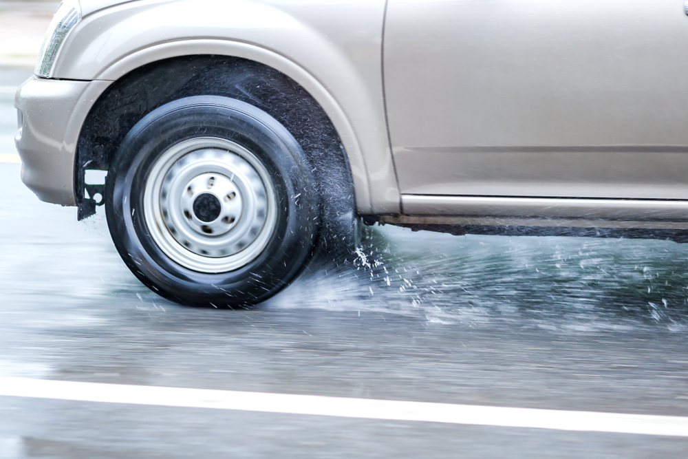 car driving through puddles on road