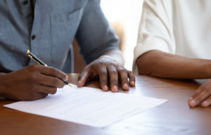 couple signing a paper