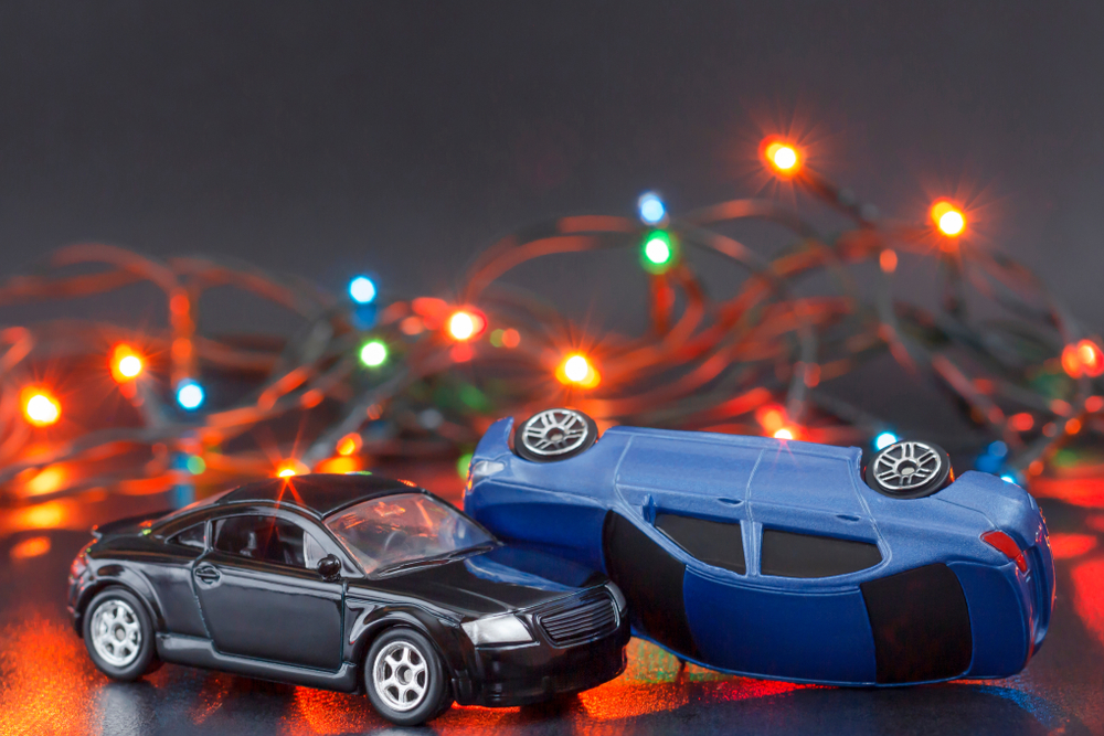 2 toy cars colliding with Christmas lights